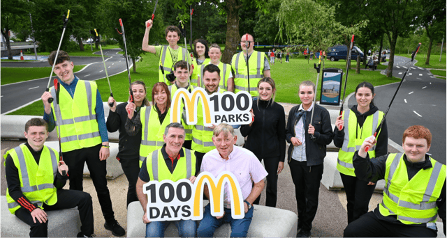 (L-R): Councillor Paul Doogue & McDonald’s Franchisee Bernard Byrne. Centre, holding sign: McDonald’s Operations Manager Manuel Jean