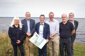Minister Andrew Muir pictured with a range of stakeholders on the shores of Lough Neagh where they discussed the new Lough Neagh Report and Action Plan.