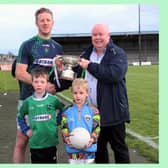 Longford Leader Managing Editor Alan Walsh, with his son Iarla, presents the Leader Cup to Clonguish captain Joe O'Brien, with his son Cillian Picture: Syl Healy