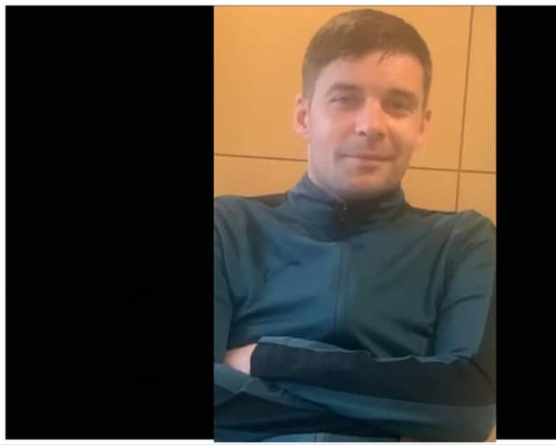 When last seen, Jonathan was wearing a green tracksuit with a black trim on the side.