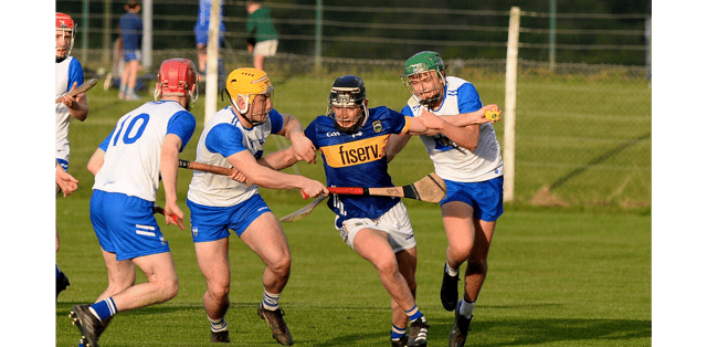 Tipperary's Eoin Craddock battles his way through the challenges of Waterford's Cillian Ryan and Scott Fleming. Picture: Michael Boland