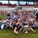 The delighted St. Patrick's Maghera team celebrate with the trophy.