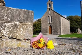 Flowers laid at the foot of Rock of Dunamase where US tourist died after being knocked down .