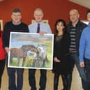 Members of the BOM of Carrig NS pictured making a presentation to retiring Principal Mr Tony Sampson before the Christmas break.