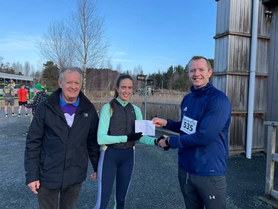 Will Faulkner Midlands 103, presents the first female home Emily Grennan with her prize in the Lough Boora Santa Dash. On left is John Bennett, organiser, Lough Boora Running Group.