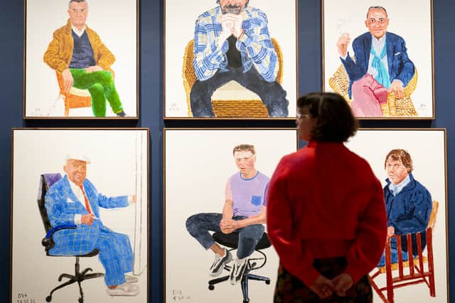 His self-portrait shows him smiling while dressed in a blue checked suit with a white cap.