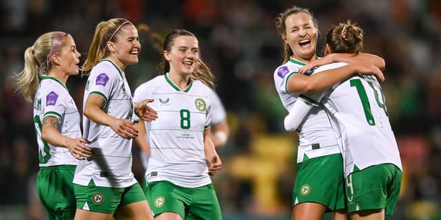 Erin McLaughlin and Tyler Toland celebrate with goalscorer Kyra Carusa. Photo: Sportsfile