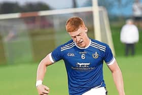 Sean Healy  sending Naomh Mairtin attacking. ALL PHOTOS: ARTHUR KINAHAN