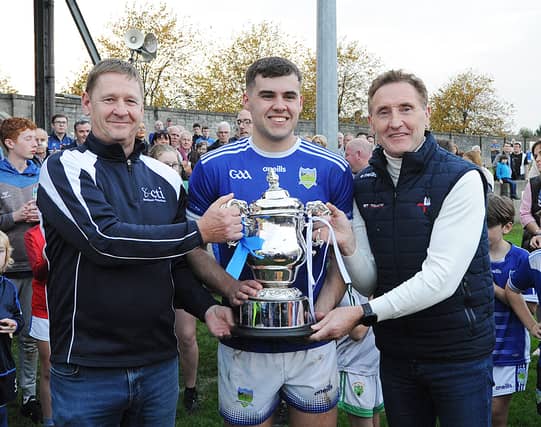 Glen Stewart, Captain of Roche Emmets, receiving the Cti Business Solutions IFC cup from Billy Lawlor of the Sponsors Cti & Peter Fitzpatrick Chairman LCB after Sunday's final. Pic: Arthur Kinahan