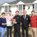 Portsalon Golf Club members take receipt of the defibrillator in 2018.