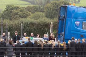 The remains of young Ronan Wilson is carried in St Mary's Church in one his the family trucks.  (NW Newspix)
