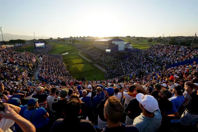 The sound which greeted them cascaded down from the top of the steeply-pitched 25-metre high grandstand, the exterior of which had been wrapped in images of faux Roman Doric columns to play on the city’s history, and reverberated around the tee.