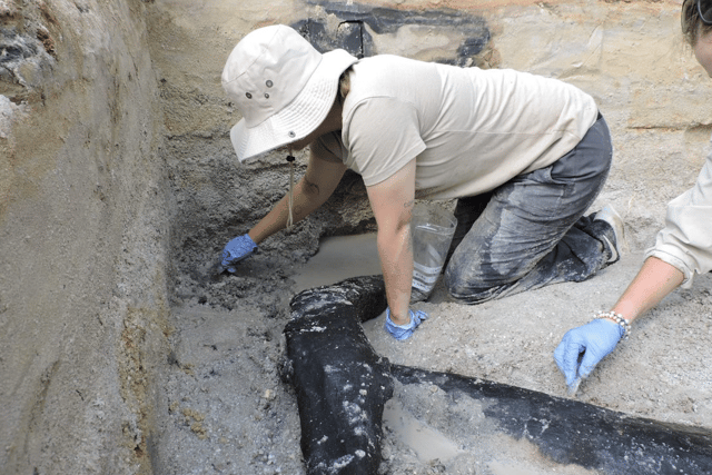 Experts said stone tool cut-marks on the wood show that early humans shaped and joined two large logs to make a structure, probably the foundation of a platform or part of a dwelling.