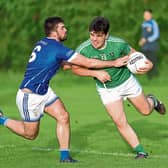 Matthew Carey on the ball for Clonguish in this tussle with Granard opponent Mark Tully. Action from the SFC Round 5 clash at Monaduff on Saturday evening Photo: Syl Healy