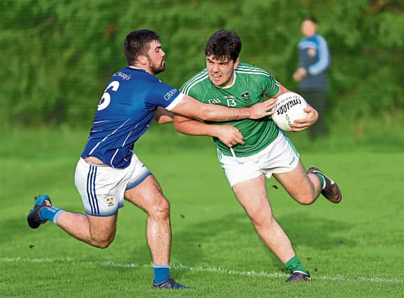 Matthew Carey on the ball for Clonguish in this tussle with Granard opponent Mark Tully. Action from the SFC Round 5 clash at Monaduff on Saturday evening Photo: Syl Healy
