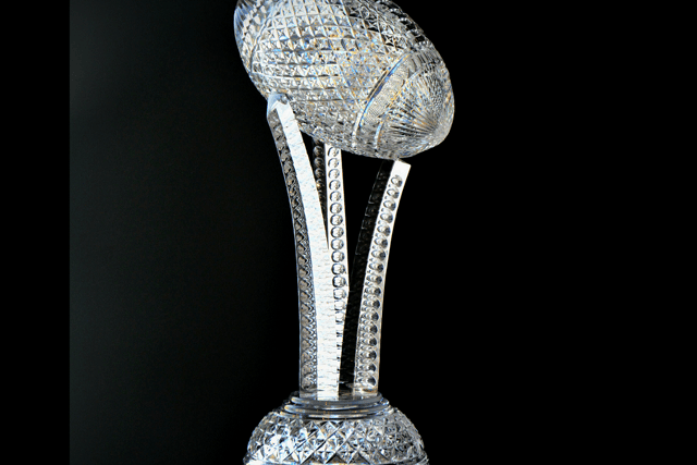 The Keough-Naughton College Trophy, designed by Matt Kehoe, Senior Designer at Waterford, depicts an American football mounted on three sculpted crystal pillars and will be awarded to the winning team.