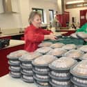 Karen Mullan (right) Foyle Foodbank helping to pack summer scheme lunches.