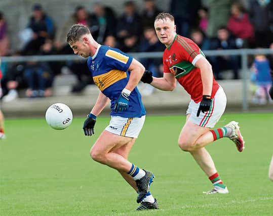 Joseph Hagan surging forward for Dromard with Mostrim opponent Tiarnan Hussey in pursuit. Action from the SFC Round 1 clash on Friday night last Photo: Syl Healy