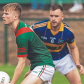 Milltown Cian Buckley weights up his options for a pass as Grangenolvin Dylan Costigan gives cover in the Tom Cross JFC. Photo: Sean Brilly