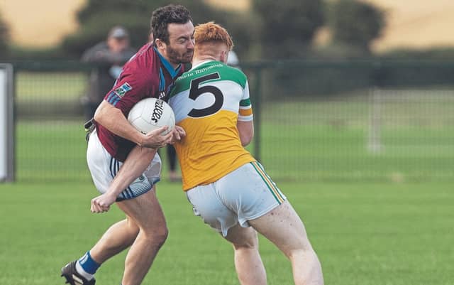 Rheban John Morrisey tries to go past the challenge of Robertstown Dara Cosgrave during Group A of the Junior Football Championship game played at Hawkfield