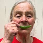 Judith Hinchliff shared a photo with a pea pod in place of her normal smile to demonstrate her happiness for pigeon pea farmers in southern Malawi