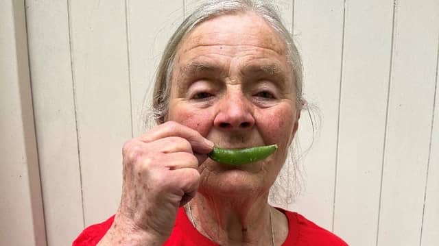 Judith Hinchliff shared a photo with a pea pod in place of her normal smile to demonstrate her happiness for pigeon pea farmers in southern Malawi