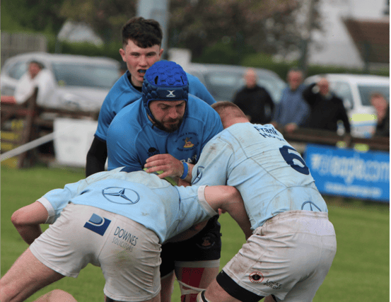 Photo from the recent Munster Junior Cup final v Garryowen played in Limerick. Kilfeacle's Keith Bourke takes on two Garryowen players. Luke Heuston awaits developments.