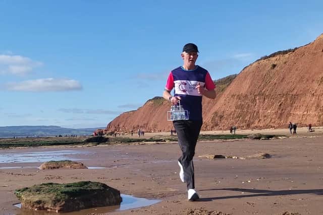 Mr Qualter will run with four plastic bottles of semi-skimmed milk as part of his his 1950s, American-style, all-white look, and has been carrying the water equivalent to practise.