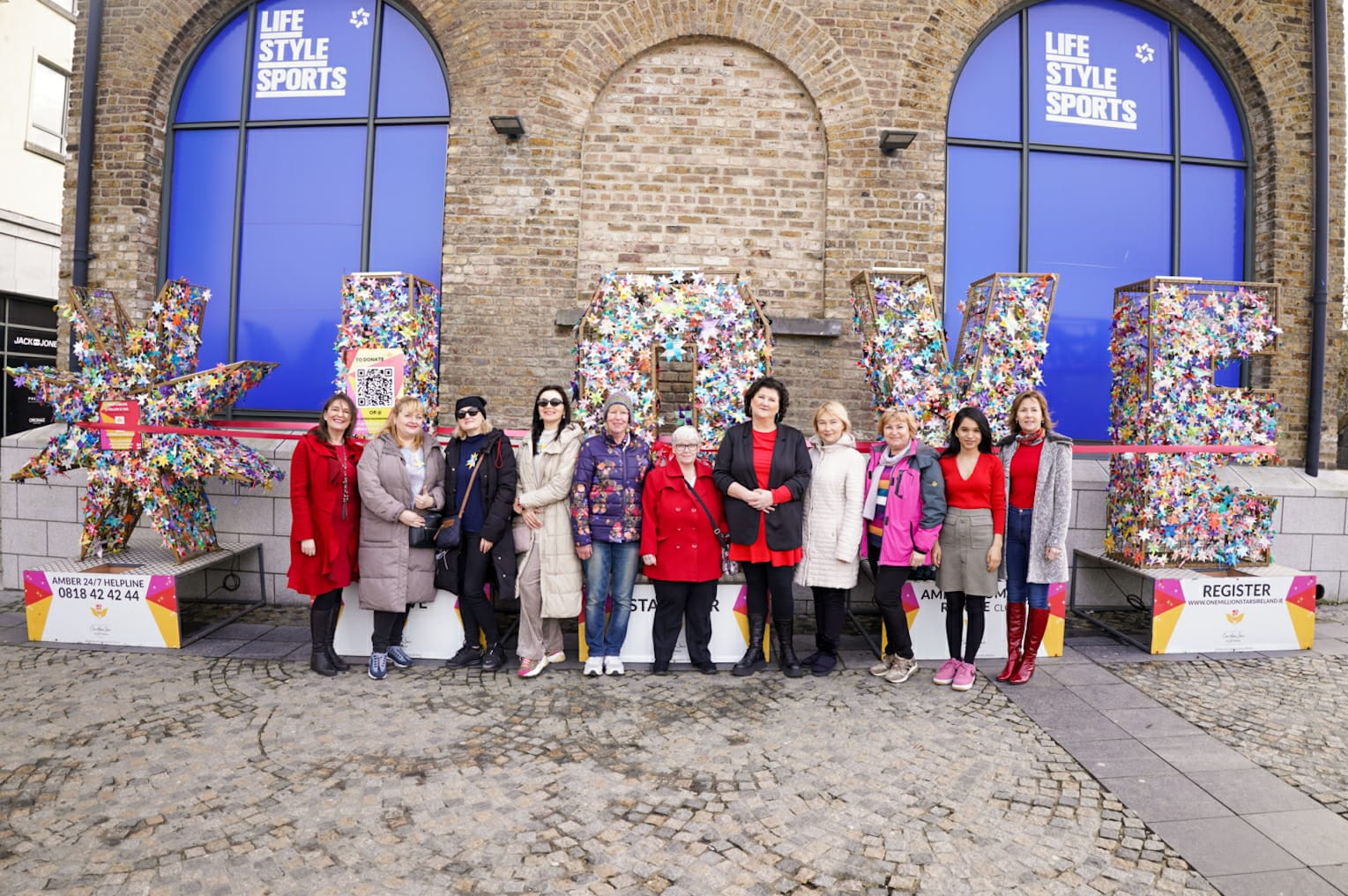 Representatives from Amber Women’s Refuge with local star weaving volunteers who, since 2020, have helped weave over 40,000 stars for the project