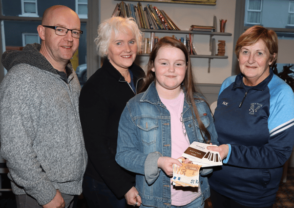 Sadhbh Feely presenting the money she raised from a recent fundraiser to Norita Kemp, a volunteer with NOVAS, also present, Sadhbh's parents, Brian and Elaine Feely Picture: Adrian Butler