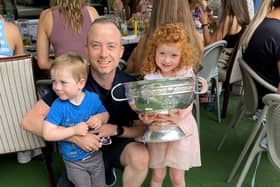 Paul Broderick with his son Andrew & daughter Hannah holding the O'Duffy Cup, at the Pembroke Hotel reception for Kilkenny's Camogie All-Ireland Champions