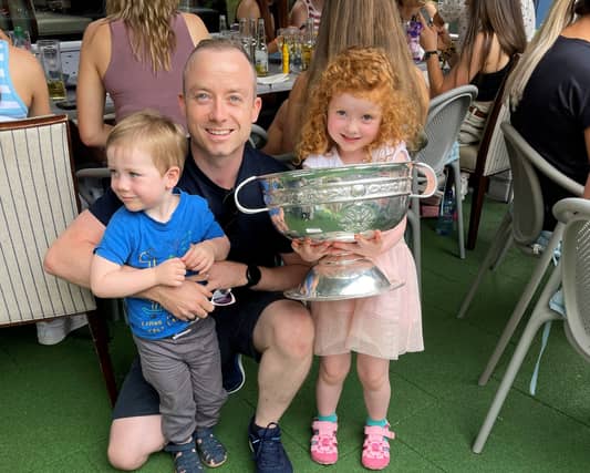 Paul Broderick with his son Andrew & daughter Hannah holding the O'Duffy Cup, at the Pembroke Hotel reception for Kilkenny's Camogie All-Ireland Champions