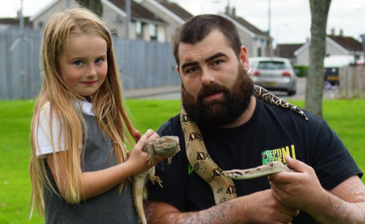 Dennis with his daughter Ellie and some of the reptiles they have rescued
