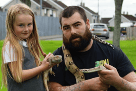 Dennis with his daughter Ellie and some of the reptiles they have rescued