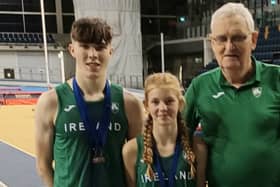 Fintan Dewhirst and Emily Kelly with Tir Chonaill AC coach Eamon Harvey.