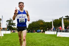 Sean McGinley crosses the line to win the junior men's race. Photo: Sam Barnes/Sportsfile