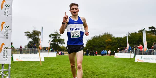Sean McGinley crosses the line to win the junior men's race. Photo: Sam Barnes/Sportsfile