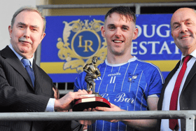 Eoin Ward is presented with the Man of the Match award by Gabriel Cronin of Cronin Dental Laboratories Drumshanbo and Leitrim GAA County Board Chairman Enda Stenson Picture: Willie Donnellan