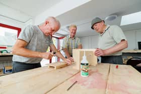 Graignamanagh Men's Shed members Vincent Doran, Paddy Corbett and Paddy Flood at work on the stools