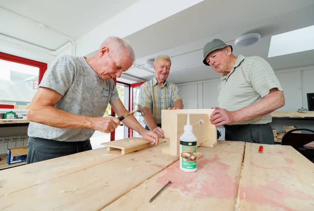 Graignamanagh Men's Shed members Vincent Doran, Paddy Corbett and Paddy Flood at work on the stools