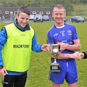 Melvin Gaels manager Thomas Lipsett and Captain Paul McGowan accepting the Cup from Leitrim GAA County Board Assistant Treasurer Noeleen Mc Loughlin Picture: Terry Williams