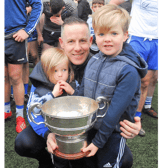 Manager Alan Flynn  pictured with his children Paudie and Seamie and the Fenagh Cup after St Mary's victory Picture: Willie Donnellan