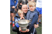 Manager Alan Flynn  pictured with his children Paudie and Seamie and the Fenagh Cup after St Mary's victory Picture: Willie Donnellan