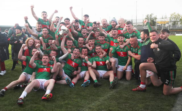 The thrilled Colmcille players celebrating with the Connolly Cup following the dramatic win over Mullinalaghta in the county SFC final Photo: Syl Healy