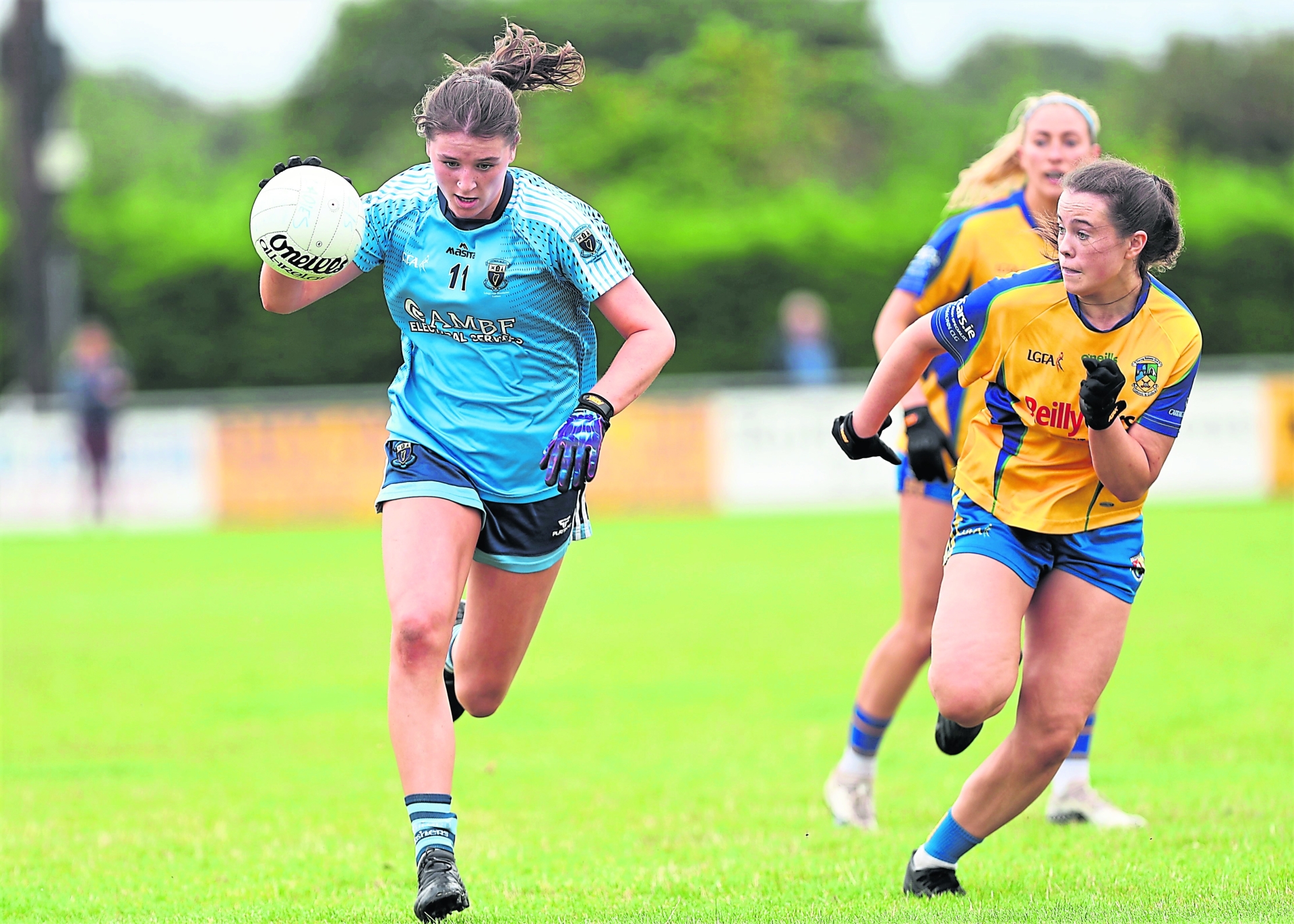 Grace Shannon surging forward for Slashers ahead of Carrickedmond opponent Ciara Mulligan. Action from the Ladies SFC semi-final on Sunday Photo: Syl Healy