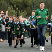 Mark English and Sean McGinley lead the Glenswilly NS athletes on a lap of their new track. Photos: Thomas Gallagher