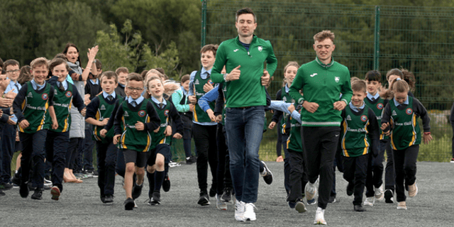 Mark English and Sean McGinley lead the Glenswilly NS athletes on a lap of their new track. Photos: Thomas Gallagher