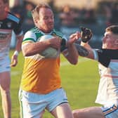 Robertstown Anthony Moran pushes past the challenge of Grangenolvin Lee Doyle. Photo: Sean Brilly