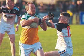 Robertstown Anthony Moran pushes past the challenge of Grangenolvin Lee Doyle. Photo: Sean Brilly