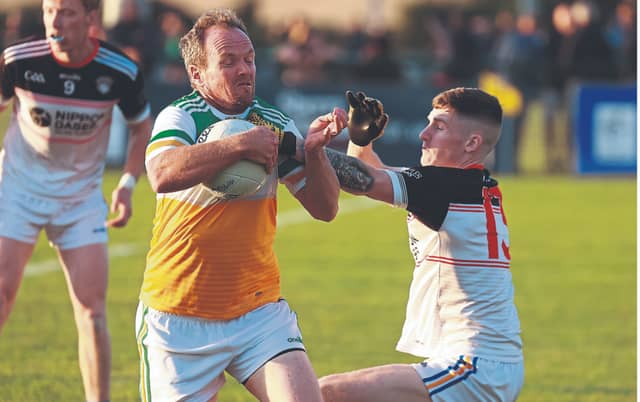 Robertstown Anthony Moran pushes past the challenge of Grangenolvin Lee Doyle. Photo: Sean Brilly